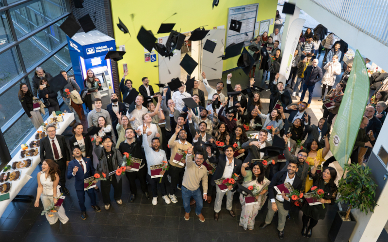 Throwing hats at the FEIT graduation ceremony on November 29, 2025